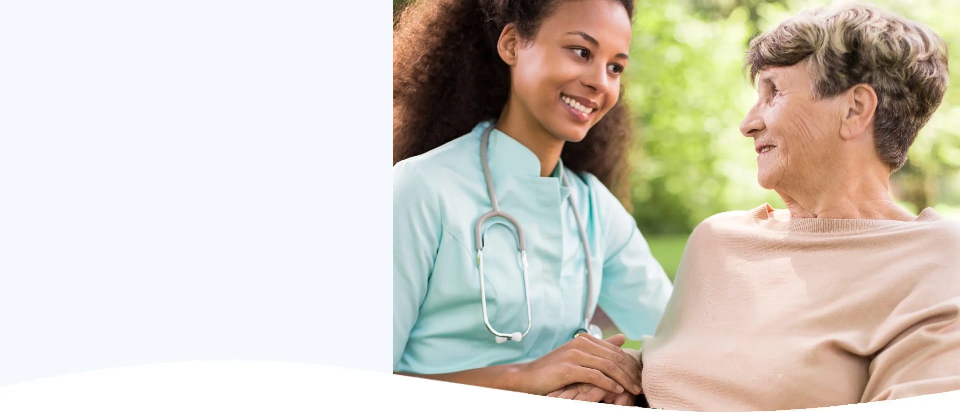 Smiling female healthcare professional with stethoscope in a bright medical setting.